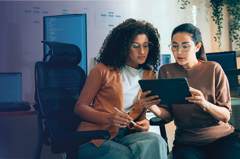Two women looking at a tablet.