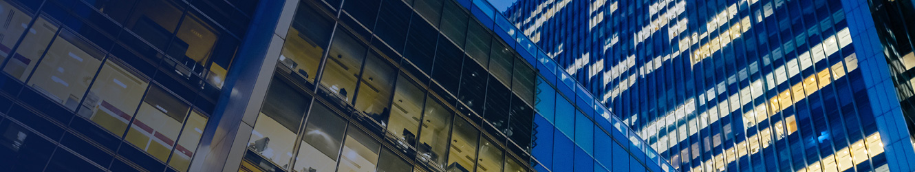 Exterior of office buildings at night.