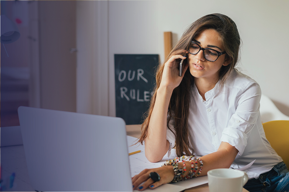 Woman on phone with a laptop